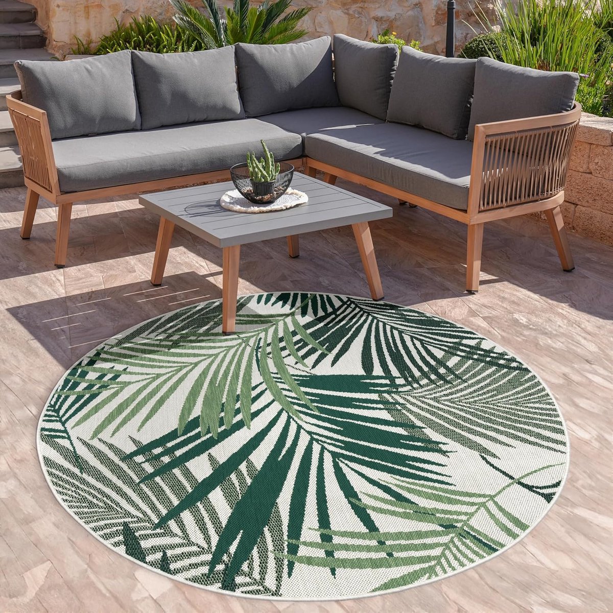 ronde buitenmat platgeweven met palmen en bloemen design